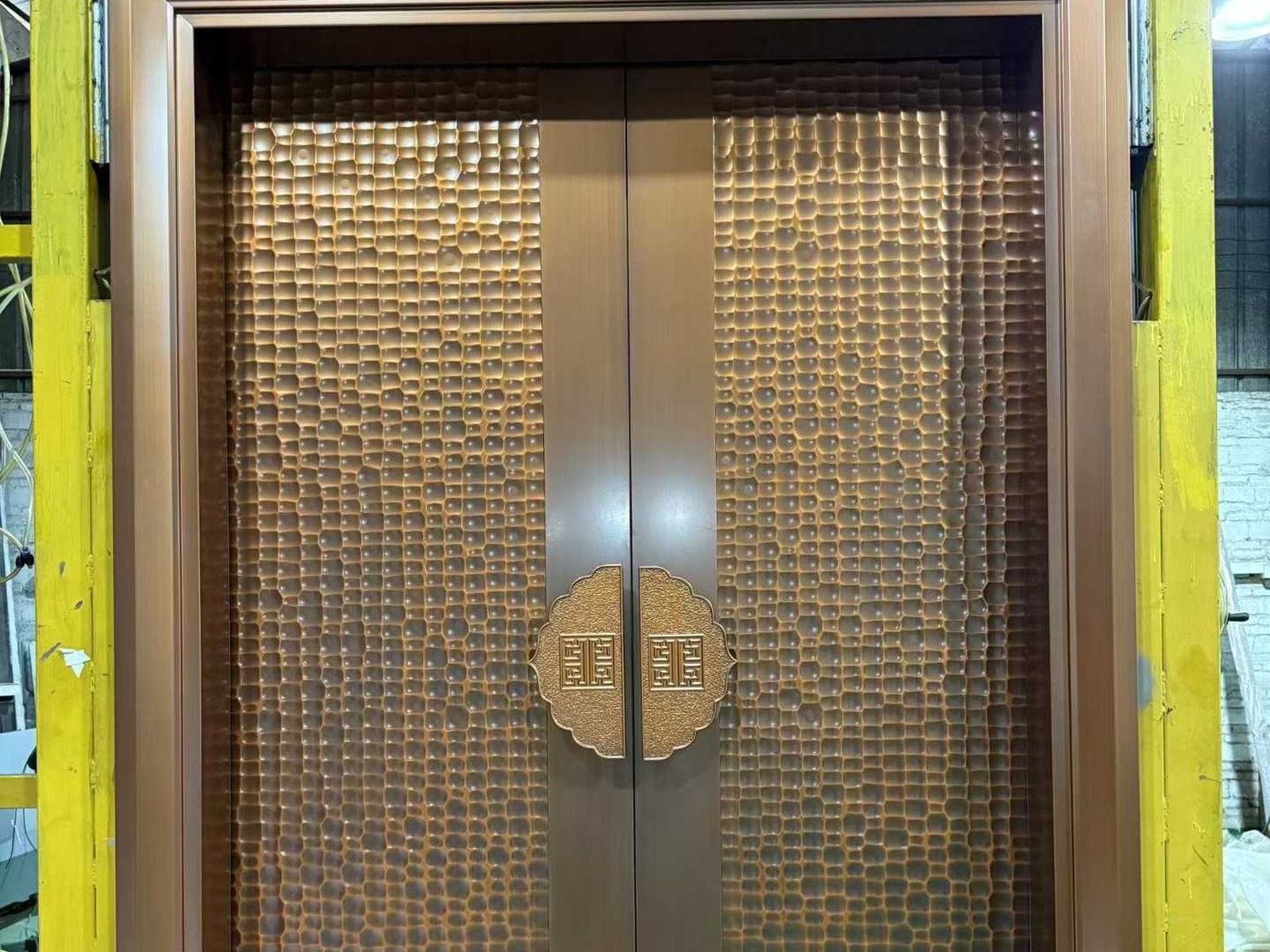 Factory exterior or entrance with the company sign visible